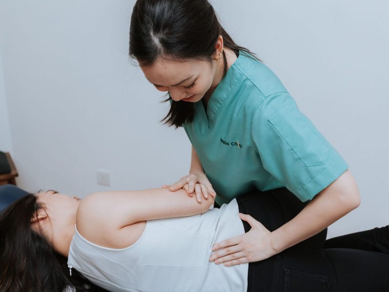 A chiropractor giving a hands-on shoulder adjustment