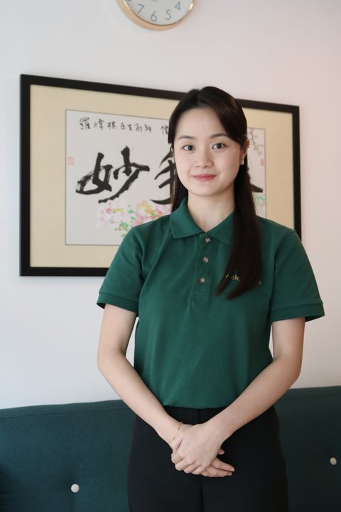 Portrait of Gladys in a green polo