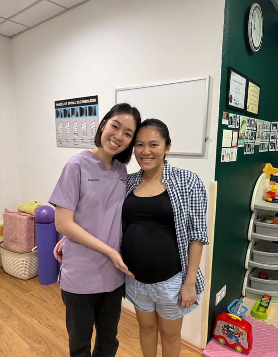 A Welo chiropractor with an expectant mother at the Taman Wahyu centre